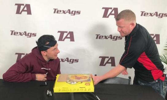 Hungry Howie's Pizza Aggieland with a picture of their Heisman Trophy Pizza signed. (Jeremiah Patrick) 2