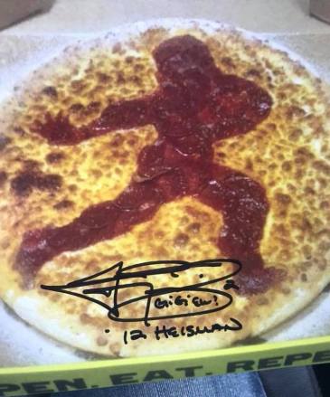 Hungry Howie's Pizza Aggieland with a picture of their Heisman Trophy Pizza signed. (Jeremiah Patrick)